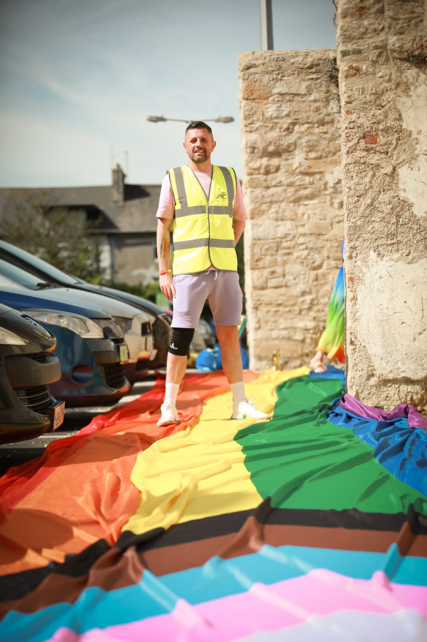 Man posing on pride flag